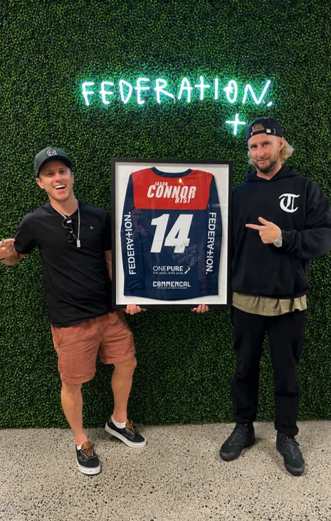 Holding a framed Federation number 14 jersey